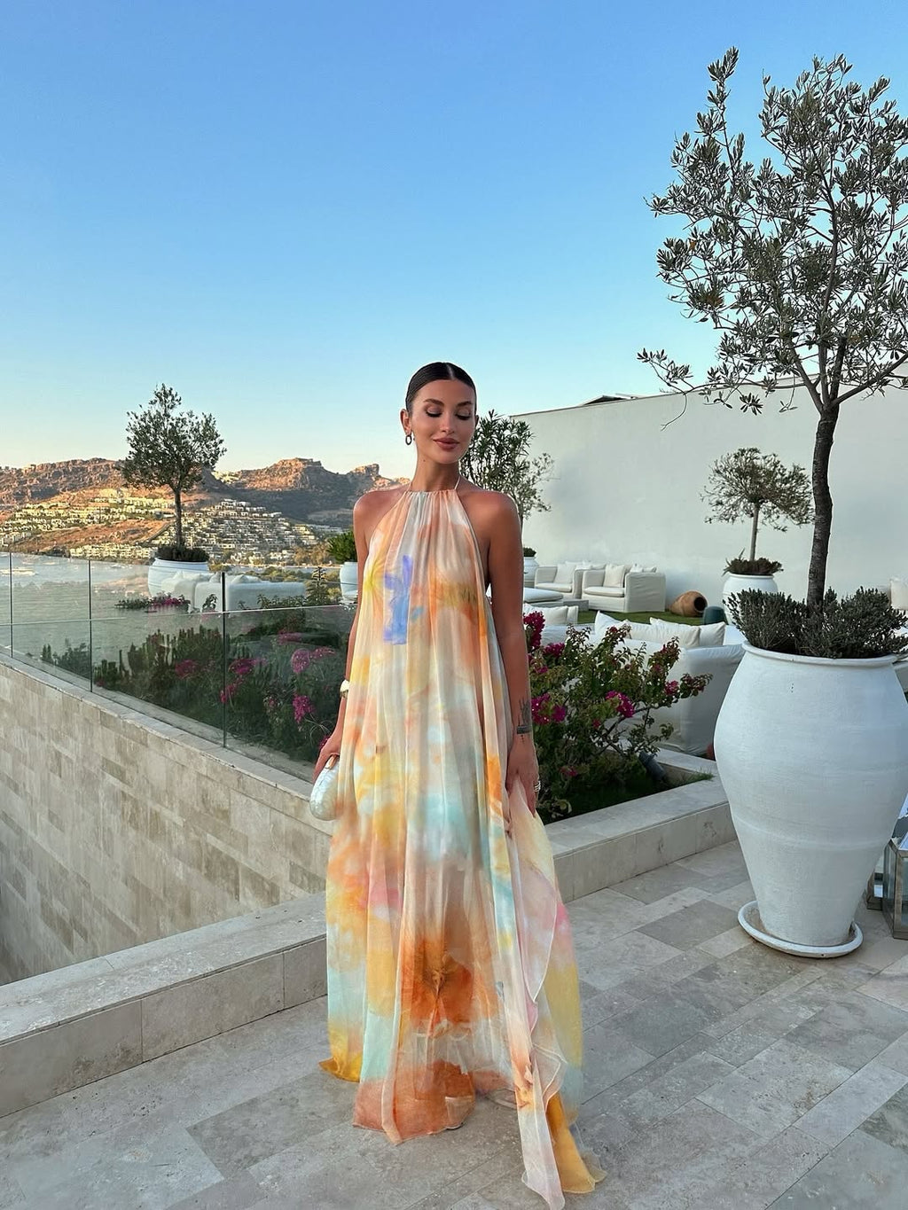 Orange printed halter maxi dress, backless silhouette, flowing summer style