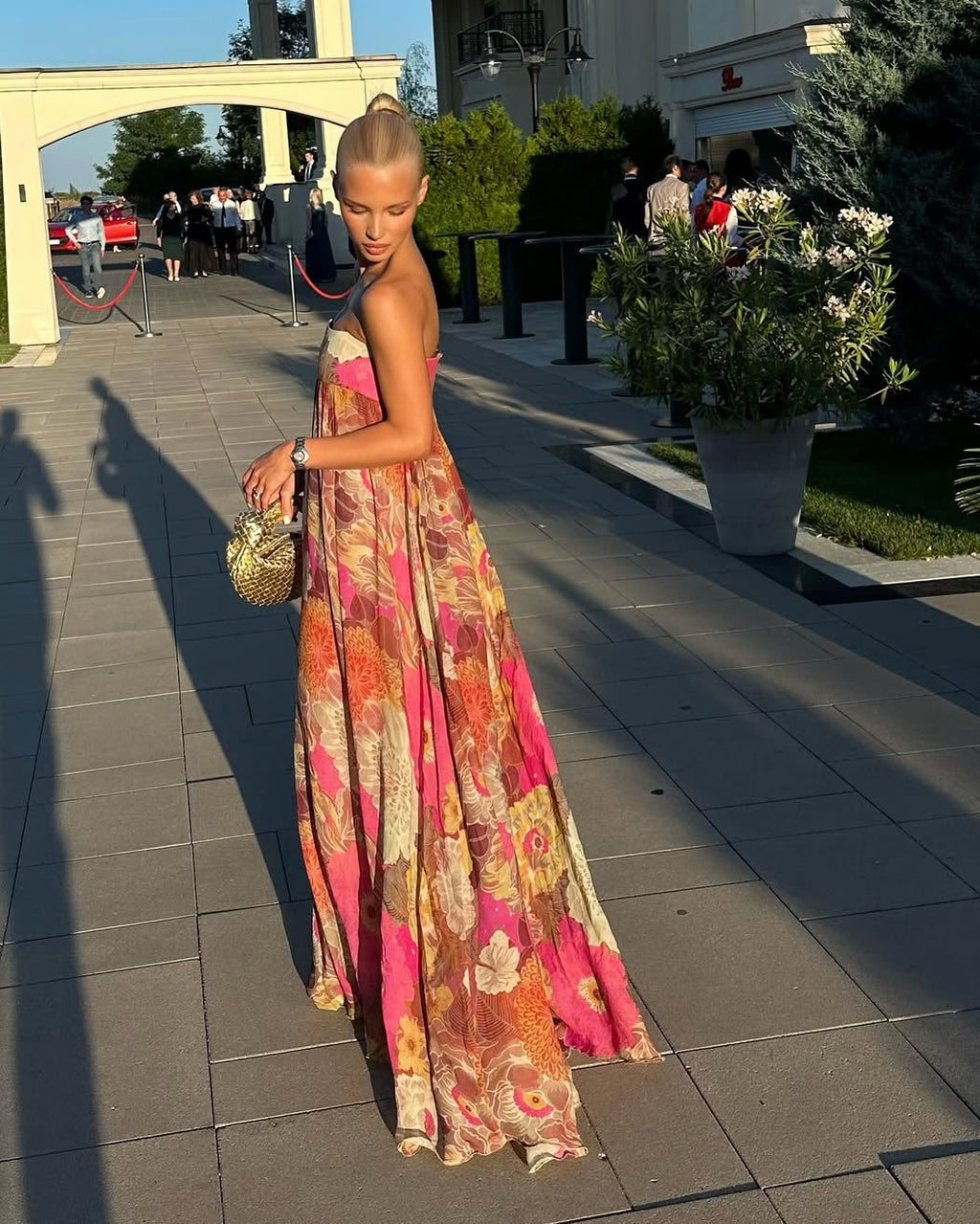 Floral strapless pleated maxi wedding dress, vibrant multicolor pattern, flowing silhouette