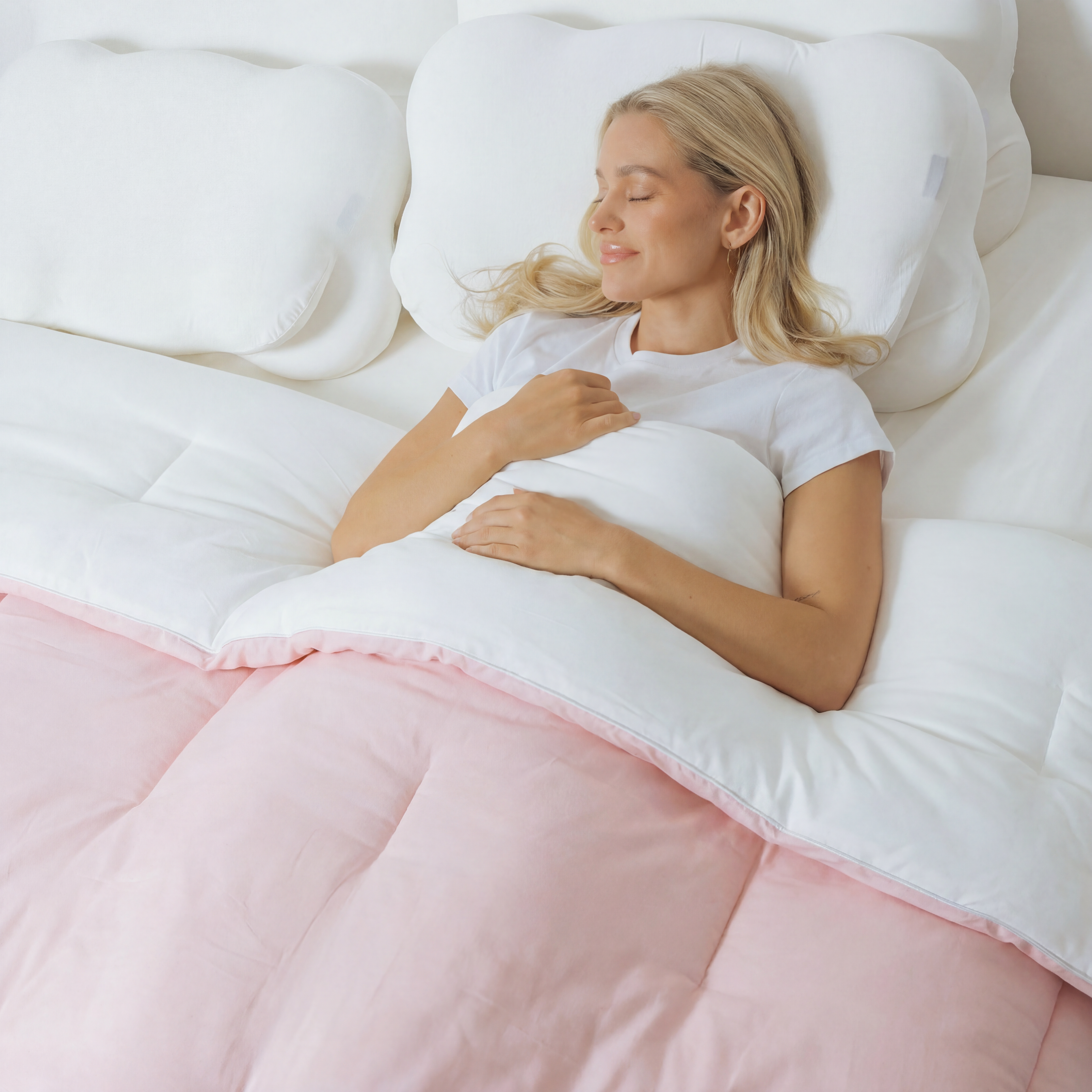 The Meringue Comforter in Baby Pink, in use on a bed