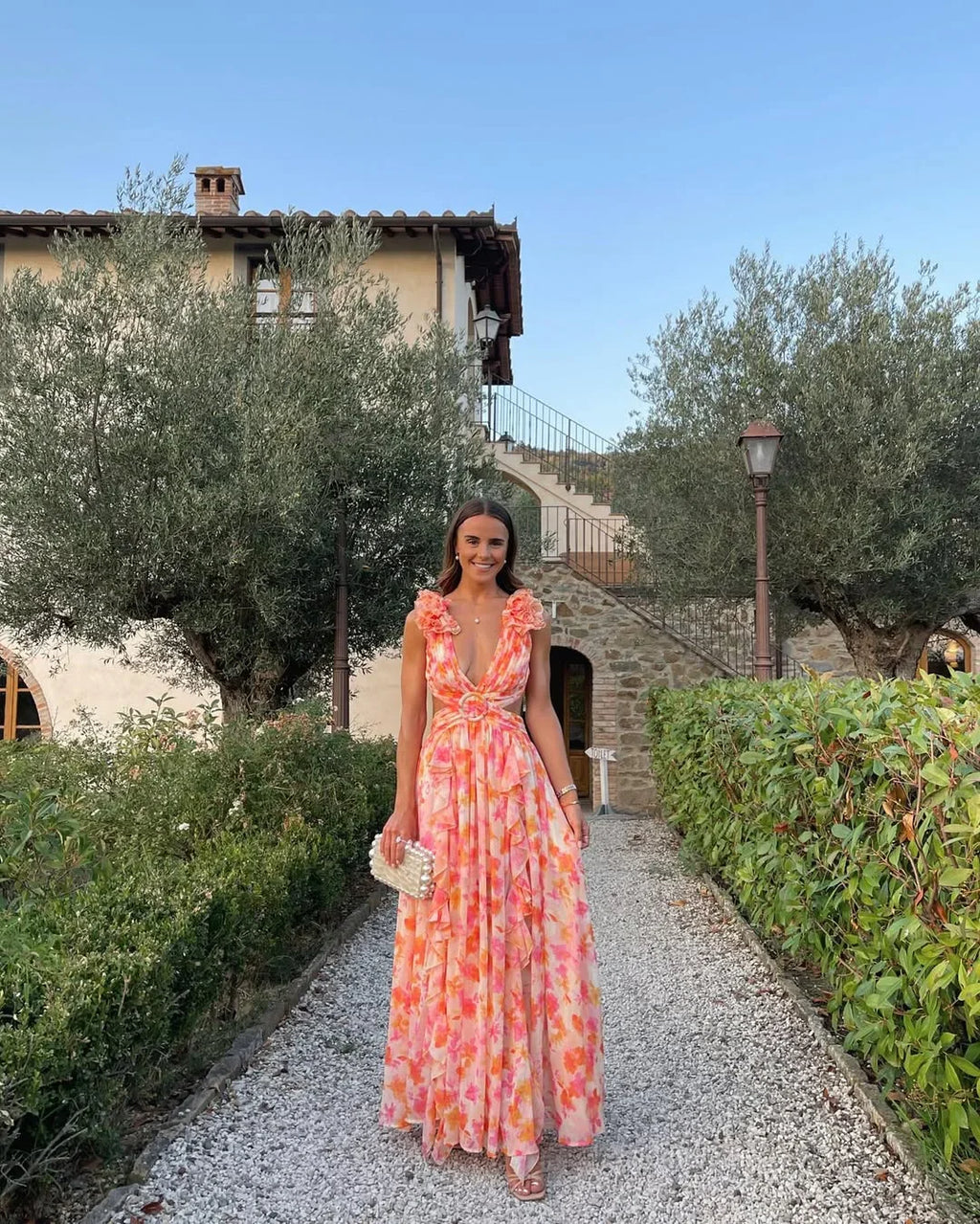 Floral sleeveless maxi dress in orange, lightweight fabric, flowing silhouette for summer